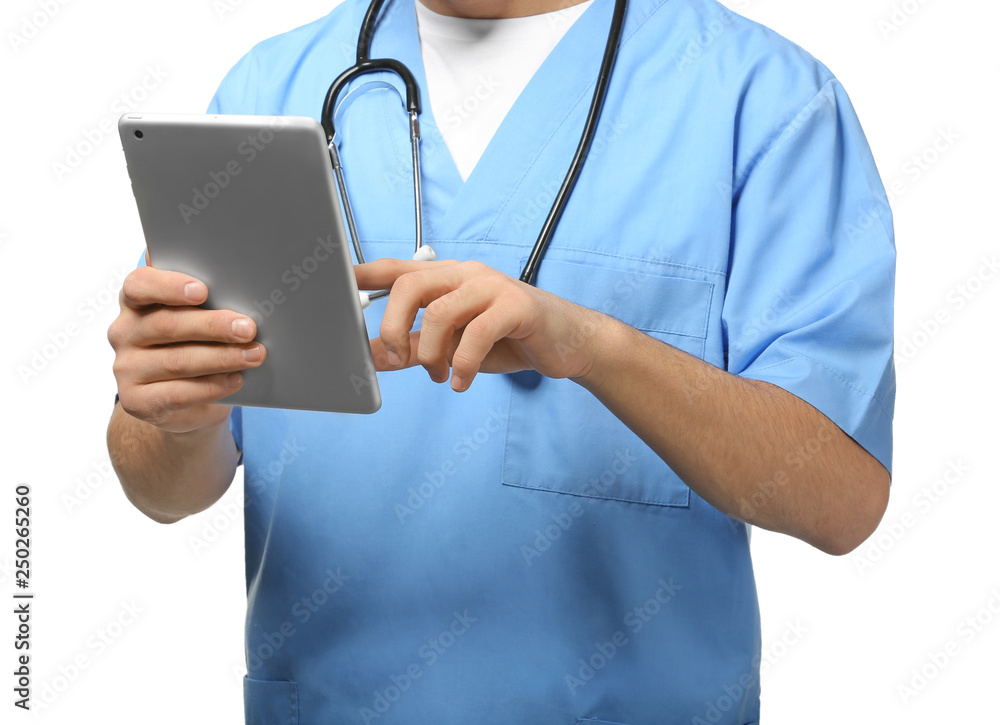 Male doctor with tablet computer on white background