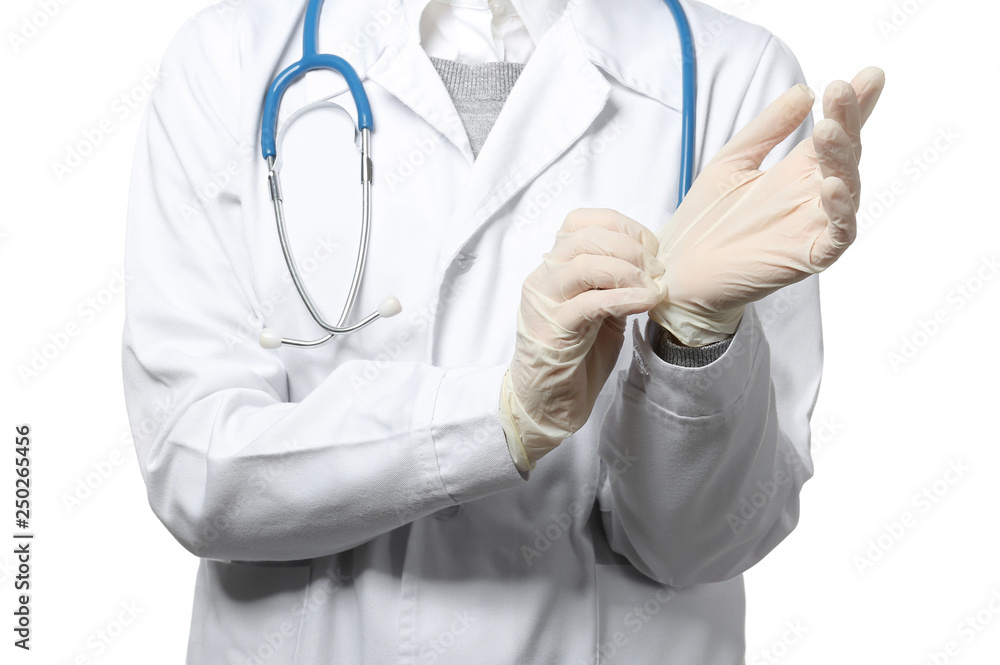 Female doctor putting on gloves against white background, closeup Female doctor putting on gloves against white background, closeup