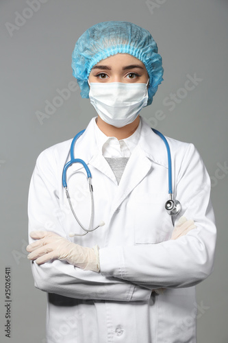 Female doctor on grey backg...