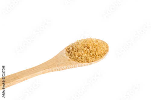wooden spoon with brown sugar, on white background