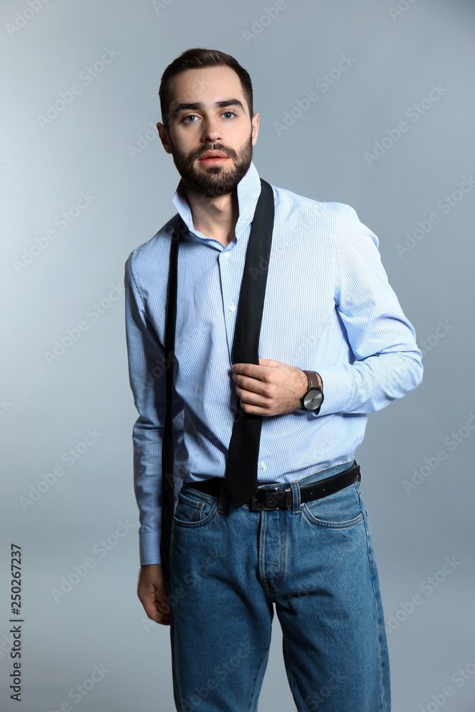 Handsome fashionable man on grey background Handsome fashionable man on grey background