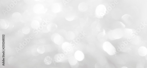 A brilliant white background with circles and ovals. Template for a holiday card with bright and sparkling lights.