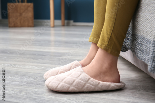 Young woman in slippers at home