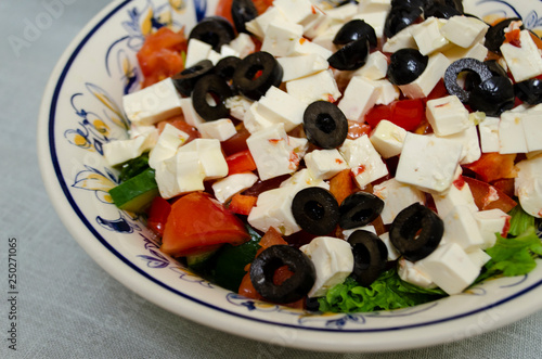 Greek salad with fresh vegetables, feta cheese and black olives