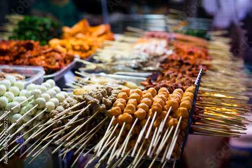 Outdoor streetfood market. Grilled BBQ meat skewers in Asia. photo