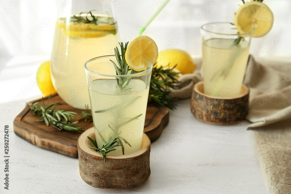 Glassware of fresh lemonade on table Glassware of fresh lemonade on table