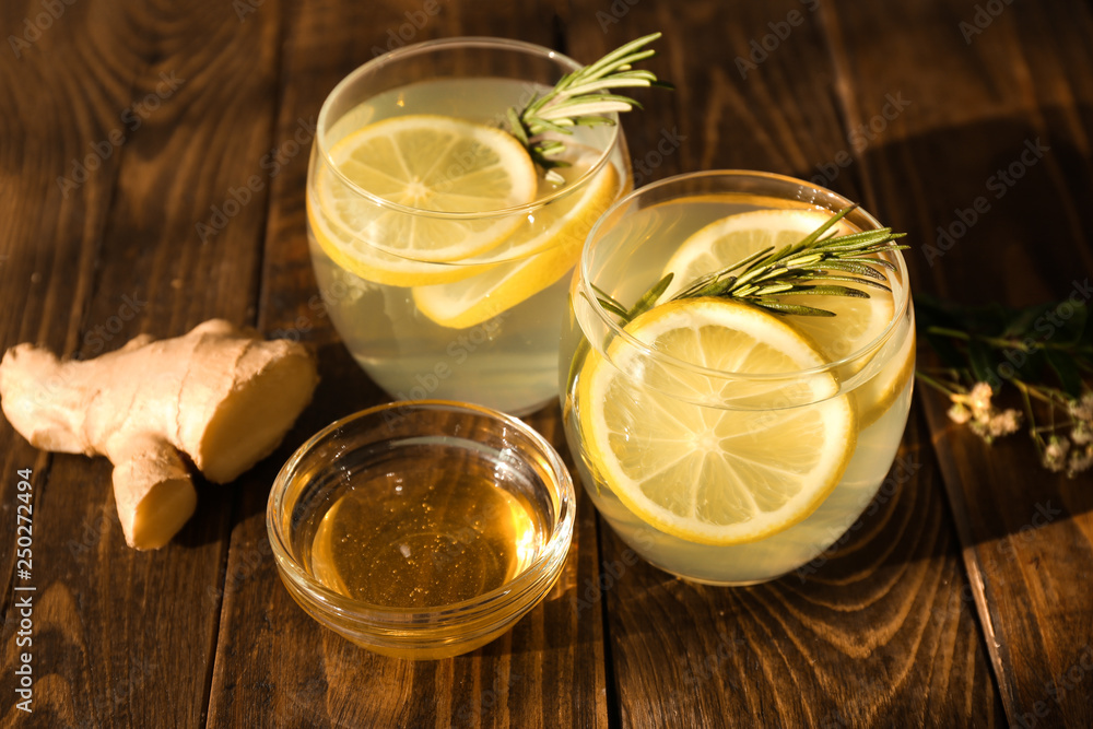 Glasses of fresh lemonade, honey and ginger on wooden table Glasses of fresh lemonade, honey and ginger on wooden table
