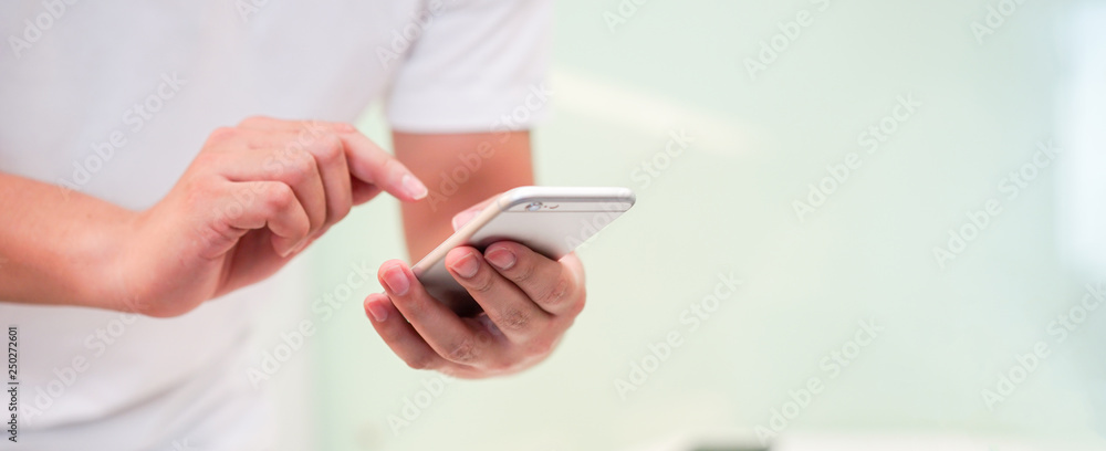 close up hand hold mobile cell phone device:focus on man play on smartphone concept close up hand hold mobile cell phone device:focus on man play on smartphone concept