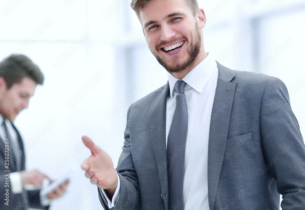 smiling businessman in the background of the office. smiling businessman in the background of the office.