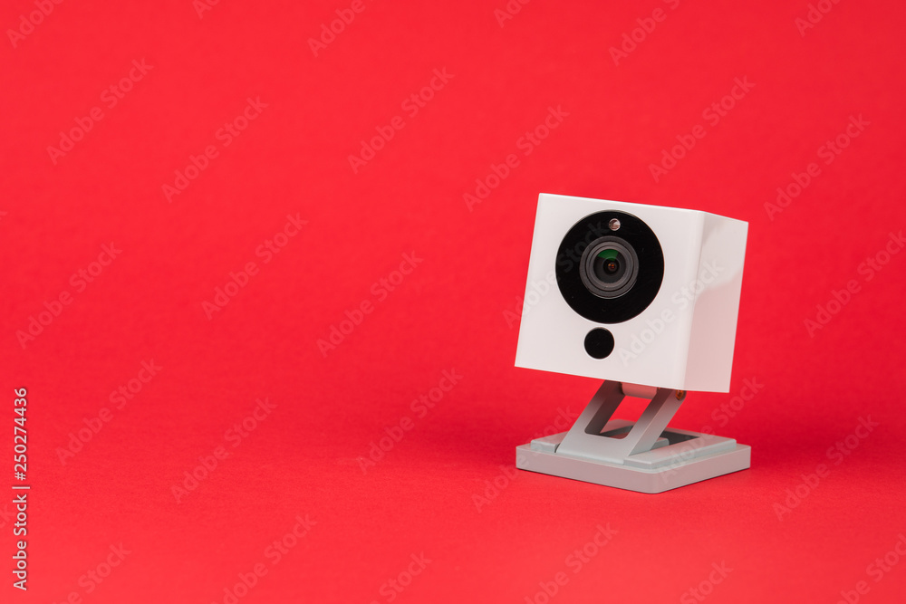 white webcam on red background, object, Internet, technology concept.
