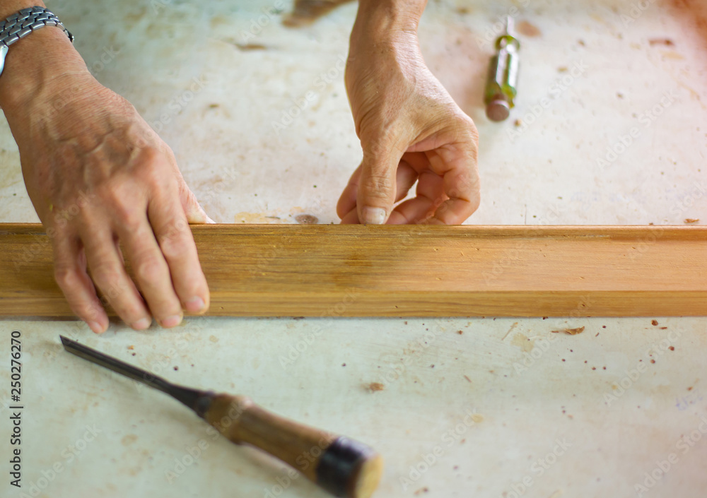 The technician is working to repair the woodwork The technician is working to repair the woodwork