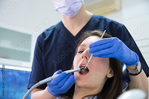 Doctor dentist examining a young lady