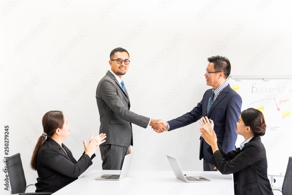 Businessmen meeting planning a joint event together and holding hands because of a successful agreement at workplace with white background to business concept. Businessmen meeting planning a joint event together and holding hands because of a successful agreement at workplace with white background to business concept.