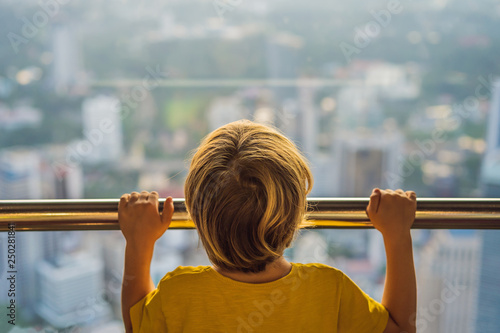 Photography Little boy looks at Kuala lumpur cityscape