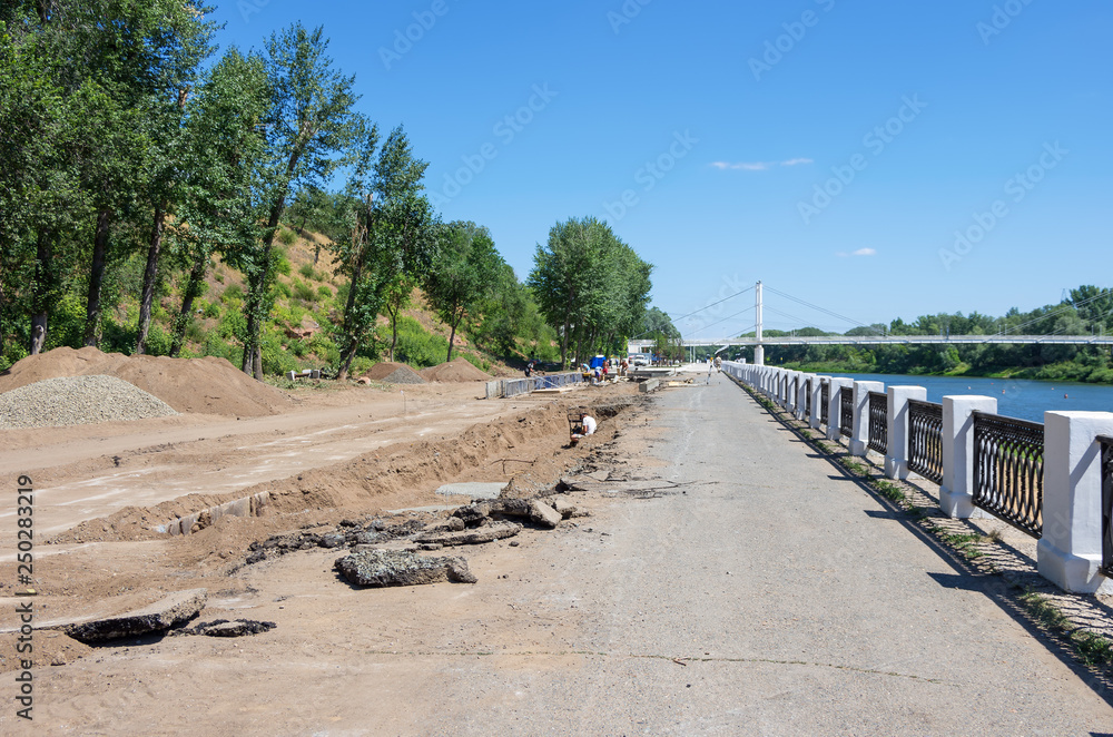 Repair and construction work on the city embankment. 08/01/2018. Russia, the city of Orenburg. Embankment of the Ural River. Elements of urban architecture