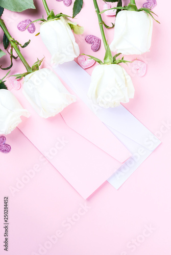 Valentines Day composition. Gift box, white rose flowers, envelope on pastel pink background. Mothers day, Womens Day Holiday concept. Flat lay, top view, copy space © lily_rocha