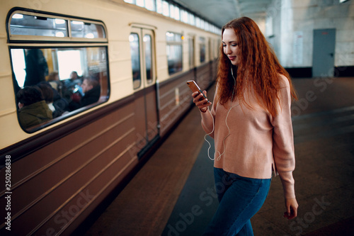 Positive redhead young female portrait. Russian subway.