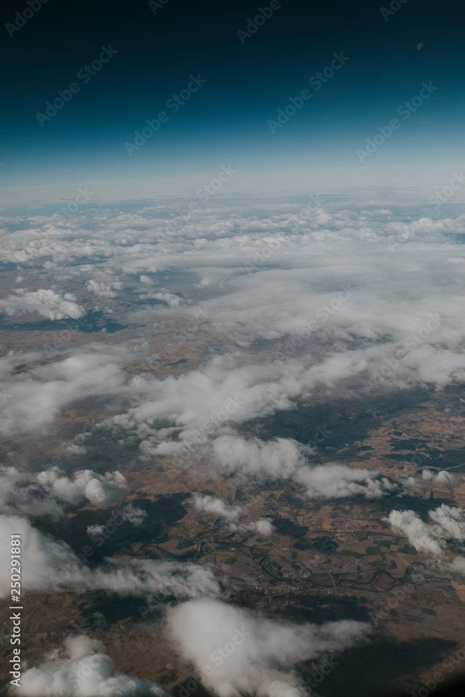 Beautiful earth and atmosphere landscape with clouds and land viewed from very high