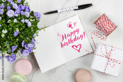 Happy Birthday postcard on white marble table