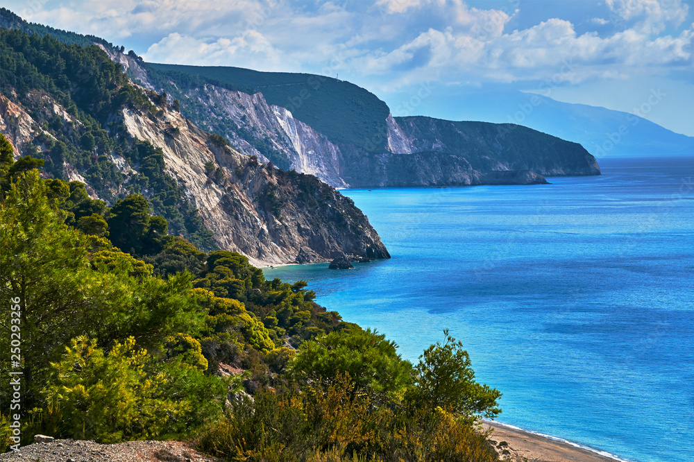Pine trees on a cliff above the sea on the Greek island of Lefkada.