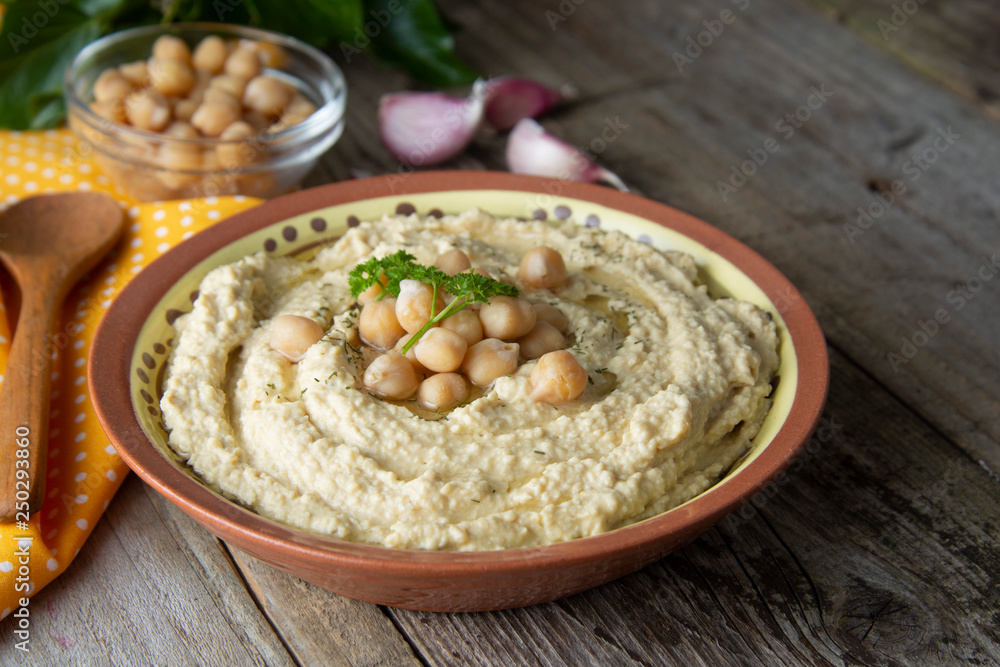 Delicious homemade hummus pasta with olive oil and chick-peas. Wooden table. Healthy food. Delicious homemade hummus pasta with olive oil and chick-peas. Wooden table. Healthy food.