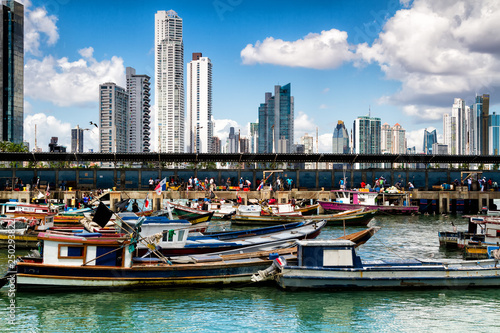 Old fishing boat in foreground with skyscrapers in background, Panama City , Panama, Central America photo