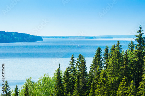 Landscape view from the top of the hill on the river Kama in the Perm region, the ship sails in the distance.