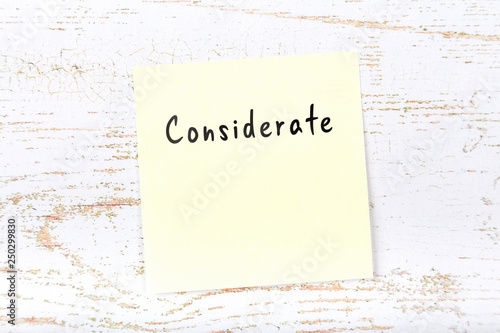 Fotografie Yellow sticky note with handwritten word considerate