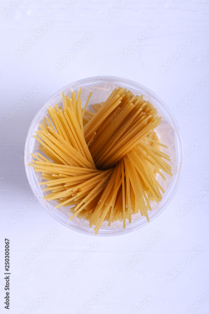 Multicolored pasta with the addition of natural vegetable dye. In a jar on a white table. Top view, copy Space. Multicolored pasta with the addition of natural vegetable dye. In a jar on a white table. Top view, copy Space.