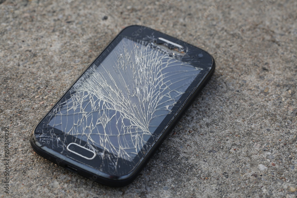 Broken, destroyed, ruined modern mobile smartphone, cell phone, mobile phone,  phone. Broken, cracked screen and damages. Device destroyed. Cell phone  crashed and scratch. Smash gadget, need repair. Stock Photo | Adobe Stock