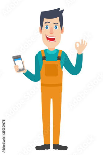 Worker holding mobile phone and showing a okay hand sign