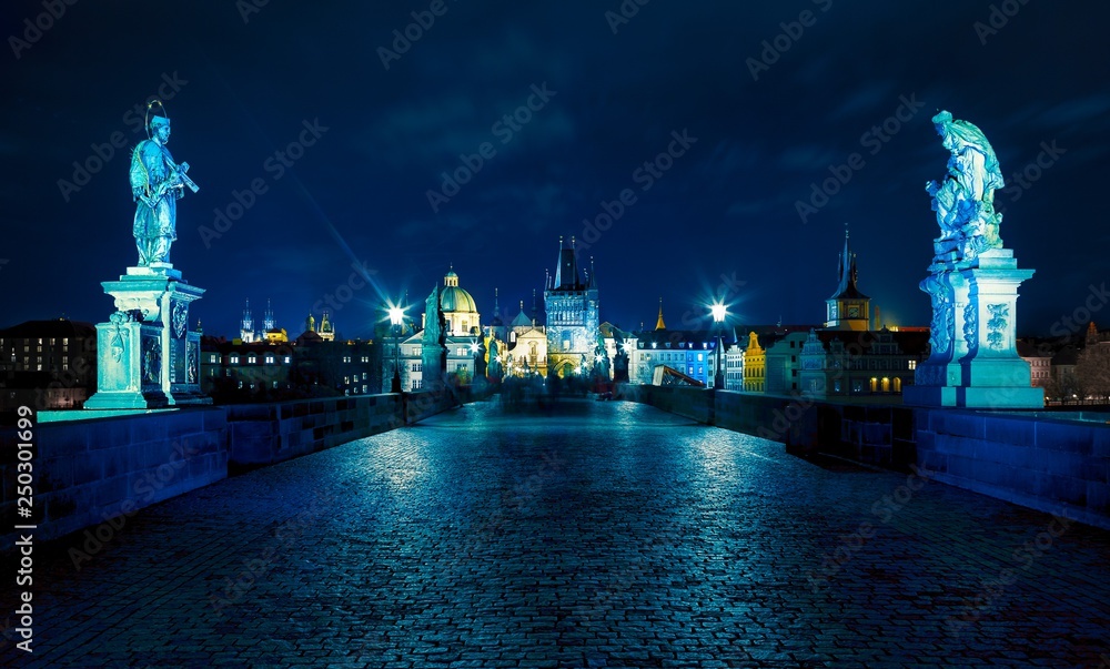 Fototapeta premium Prague. Famous Charles Bridge to the Old Town tower and St. Francis of Assisi Church (UNESCO). Czech republic, Europe. Blue night or evening.