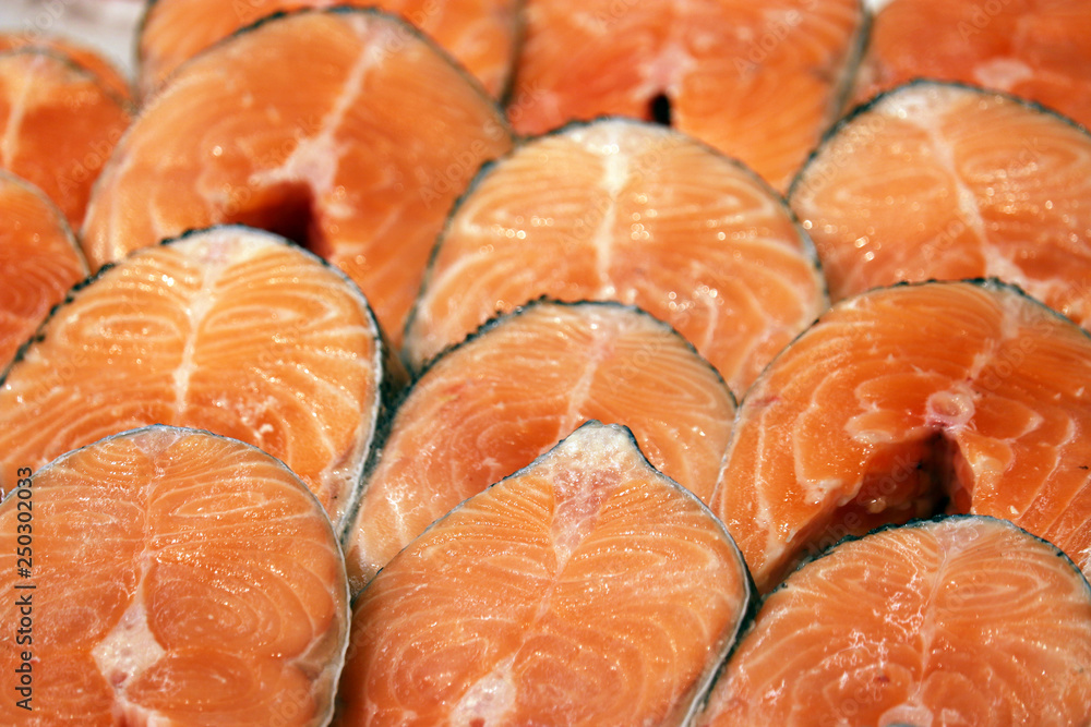 Pink salmon steaks close up for background. Raw red fish in the market, concept of healthy food, fishing industry Pink salmon steaks close up for background. Raw red fish in the market, concept of healthy food, fishing industry