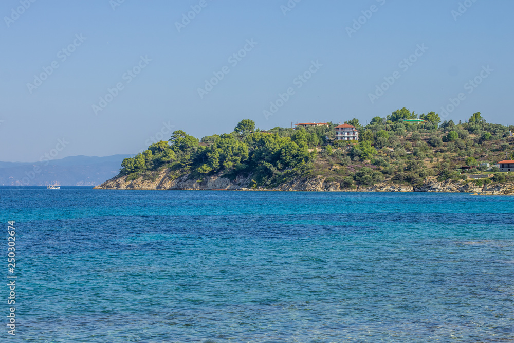 exotic sea shoreline with vivid blue water surface and underwater stone 