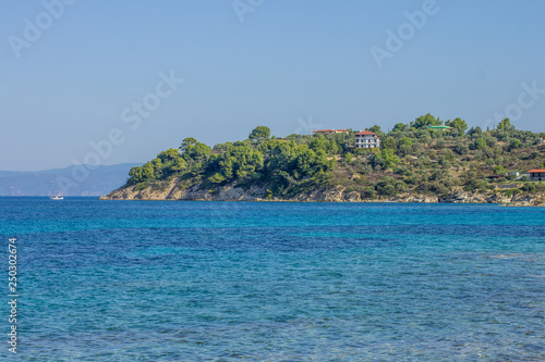 exotic sea shoreline with vivid blue water surface and underwater stone 