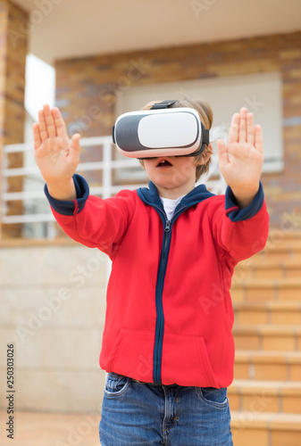 boy playing at home with virtual reality glasses