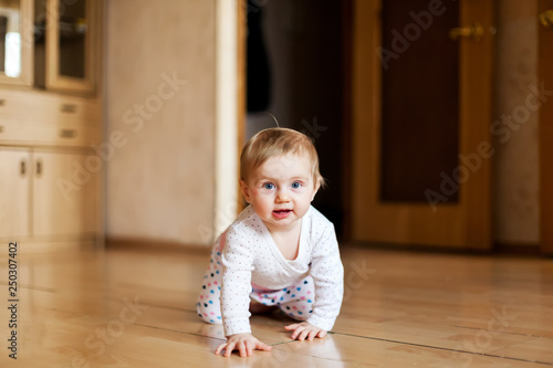 Baby crawling at home on floor
