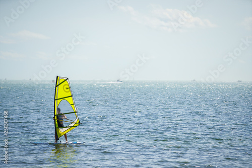 Image of an unidentifiable man wind surfing in Miami © Felix Mizioznikov