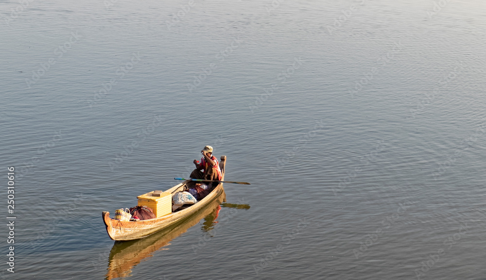 Burma, Asia -  Fisherman in a wooden boat.
