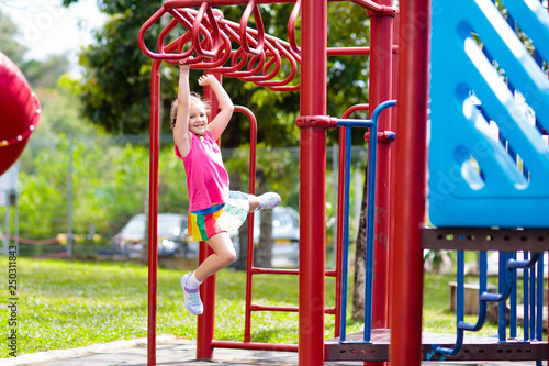Photography Child on monkey bars. Kid at school playground.