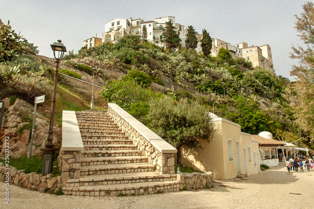 the historic center of Sperlonga photographed from below with the staircase in the closeup leading to the top the historic center of Sperlonga photographed from below with the staircase in the closeup leading to the top