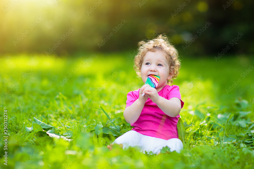 Baby girl with candy. Child with lollipop. Baby girl with candy. Child with lollipop.