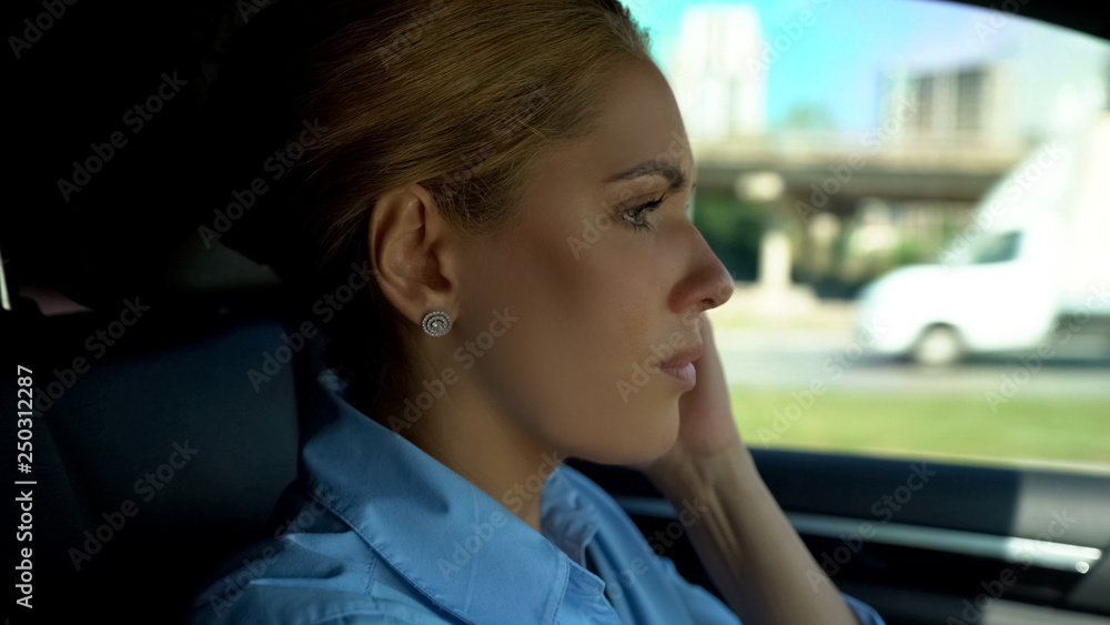 Woman feeling headache while driving, migraine symptoms, close-up of female Woman feeling headache while driving, migraine symptoms, close-up of female