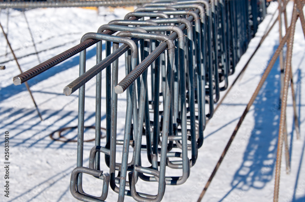 Billets of reinforcement at the construction site. Construction of the building with the help of reinforced concrete. Reinforcement of concrete base. Billets of reinforcement at the construction site. Construction of the building with the help of reinforced concrete. Reinforcement of concrete base.