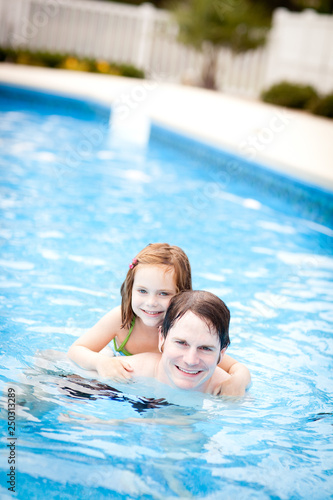 Happy Father and Daughter in Swimming Pool