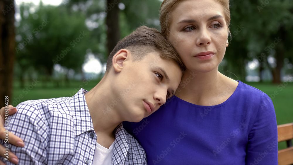 Caring mother supporting teen boy in time of trouble, bullying problem in school Caring mother supporting teen boy in time of trouble, bullying problem in school
