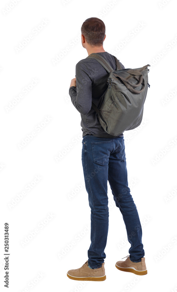 Naklejka premium Back view of a man with a green bag.