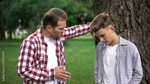 Konstfotografi Strict dad scolding son for bad marks at school, parent respect, upbringing