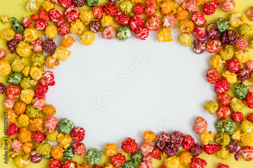 multi-colored popcorn on a bright background.concept of cinema copy spase