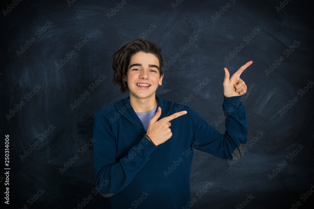 portrait of smiling teenager pointing portrait of smiling teenager pointing